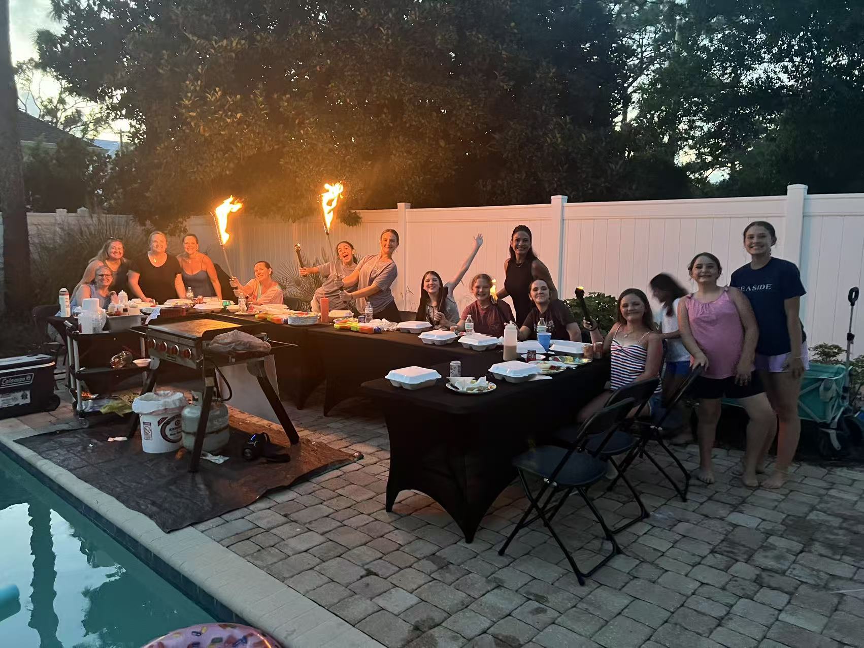 Private hibachi party setup on outdoor patio near Destin FL with guests seated around grill